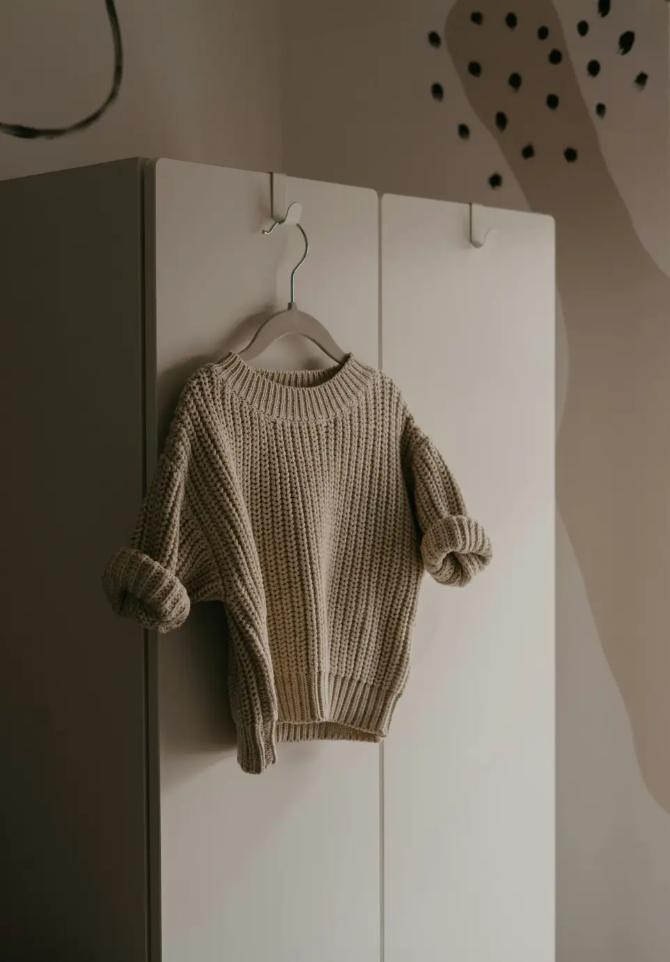 a sweater hanging on a hook in a room